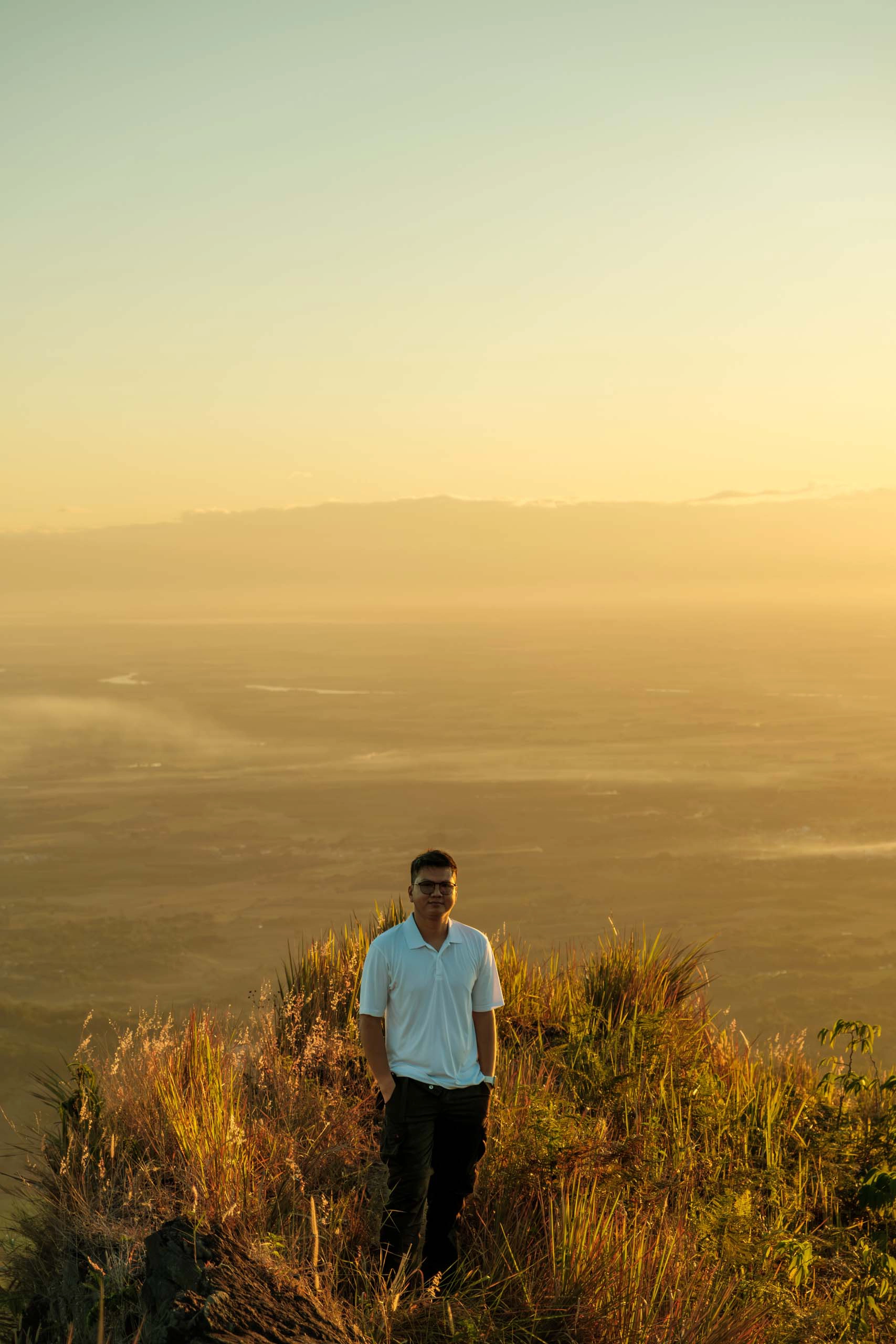 A hiker standing tall at Ugis Peak