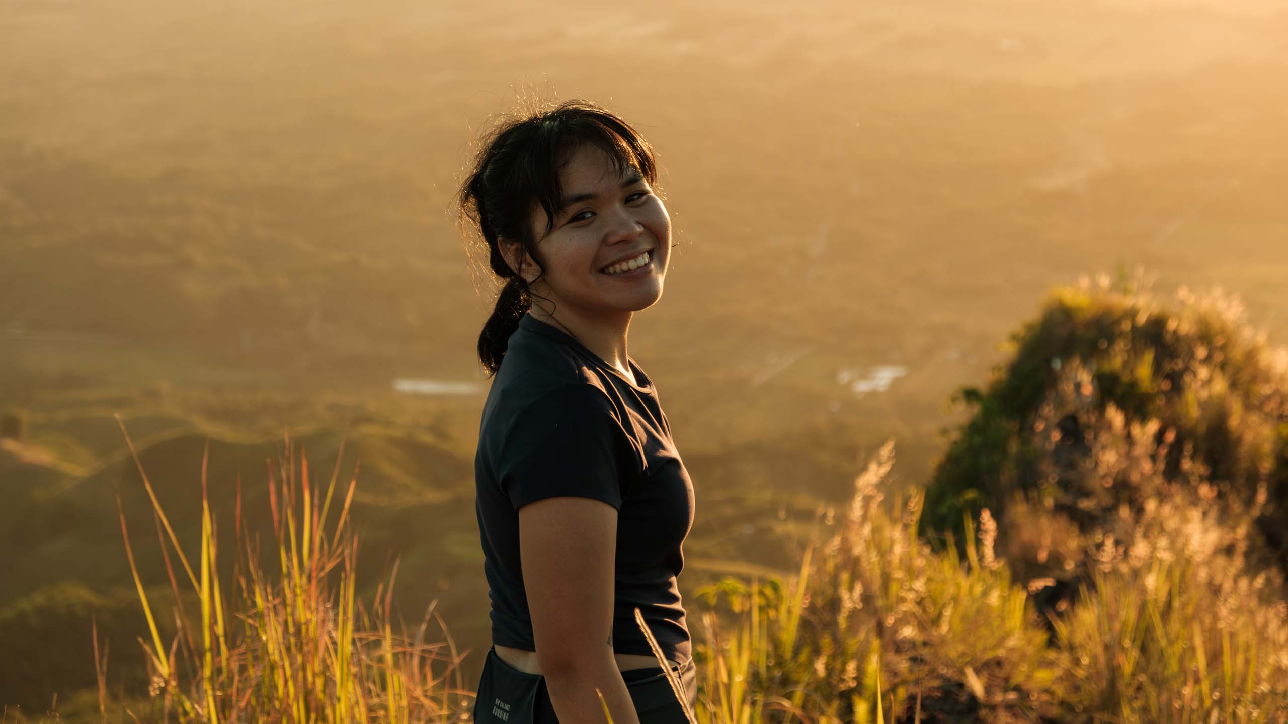 A portrait of a hiker smiling at Ugis Peak