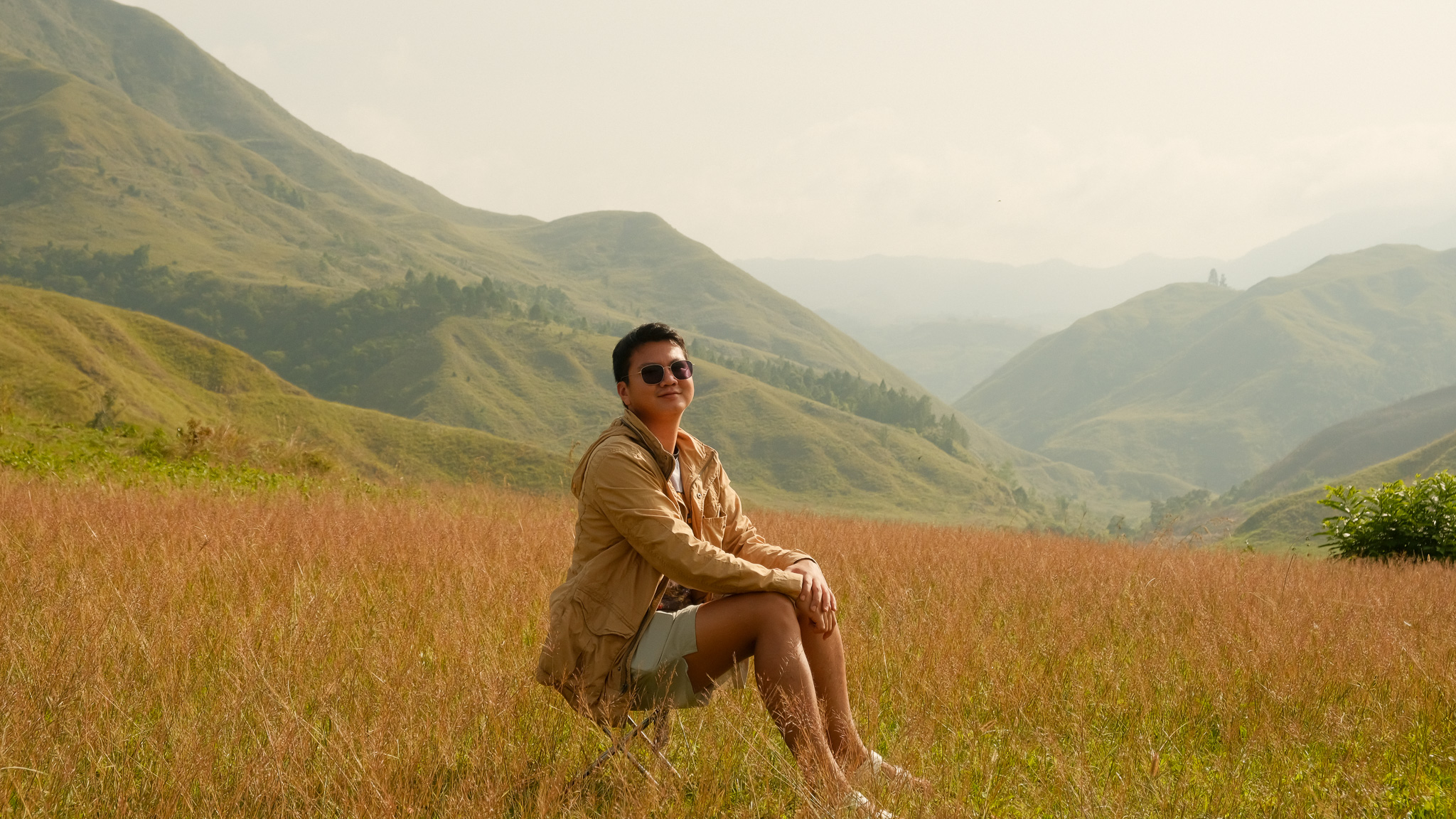 A hiker sitting somewhere in Sabangan campsite with Mt. Kiamo on his background