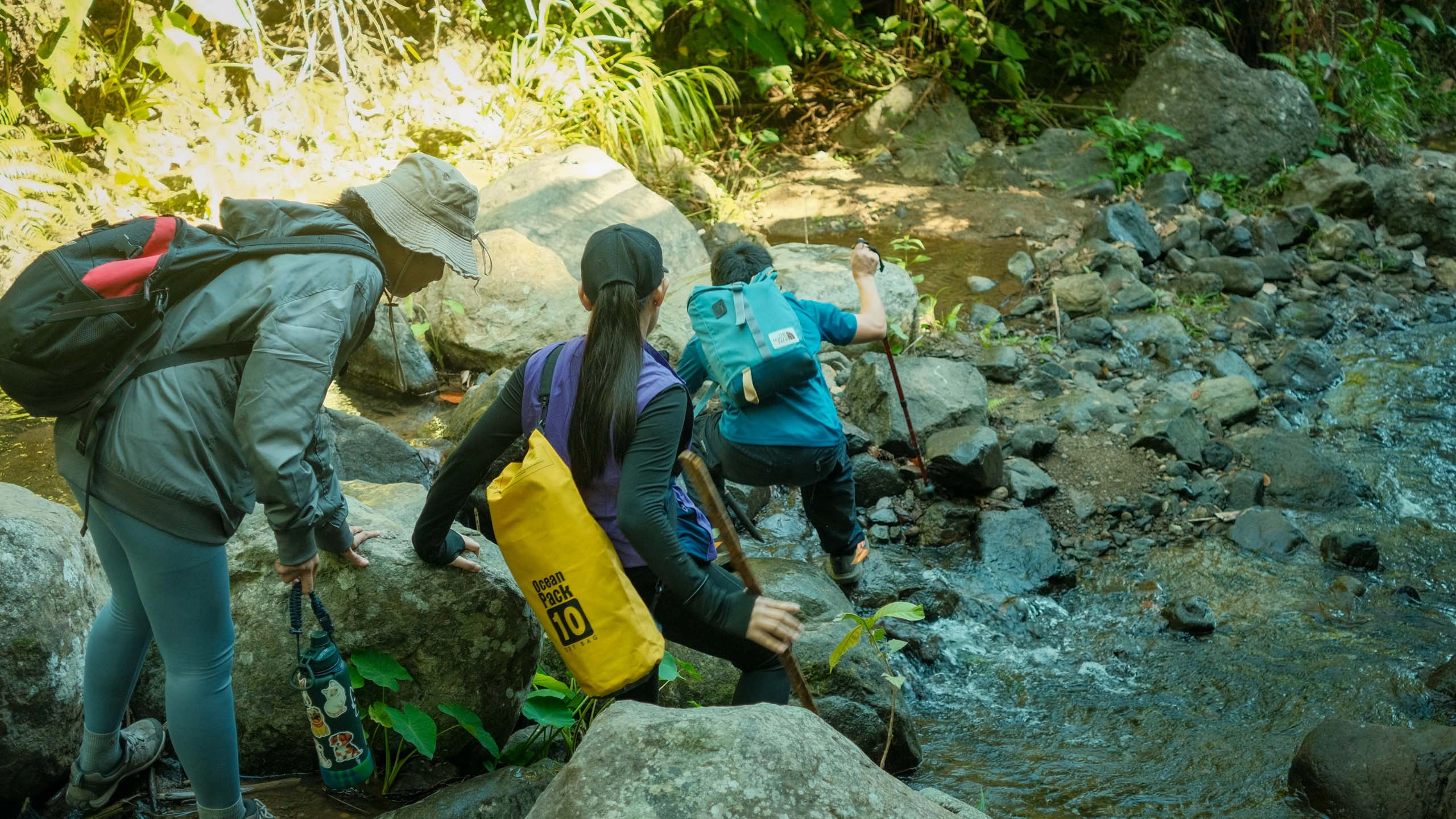 Fellow hikers walking through a river