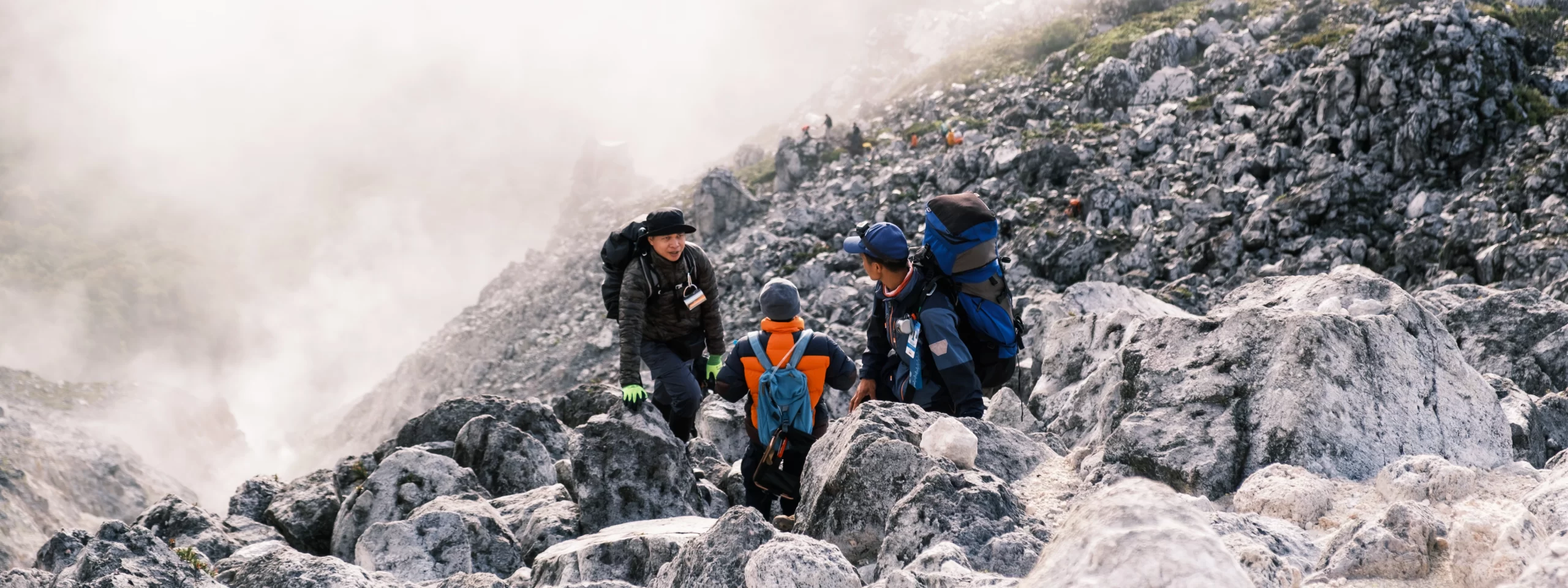 Hikers taking a pause in the middle of Mt. Apo Boulder Face