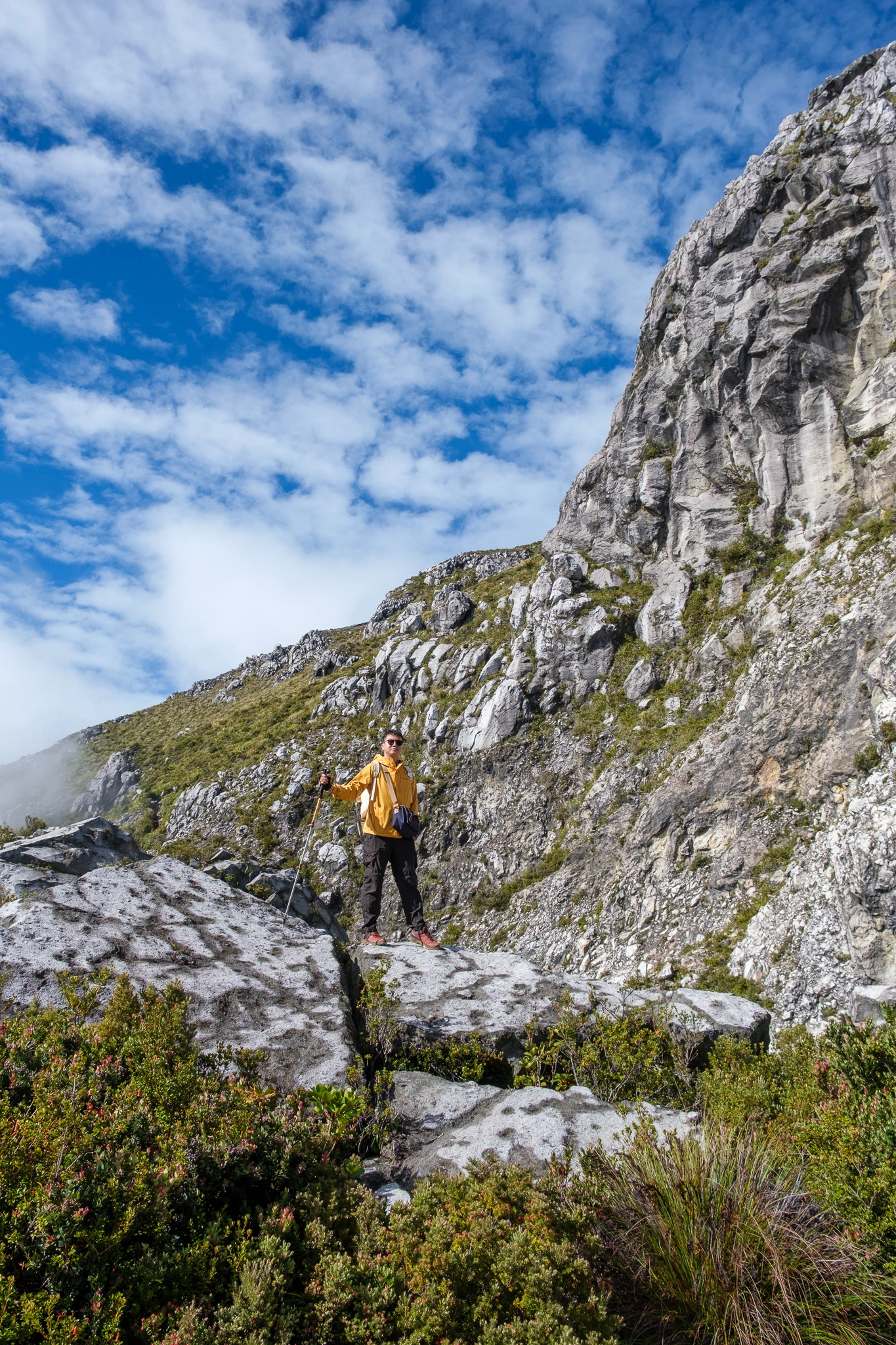 A hiker standing at a rock near the area of white sand at Mt. Apo