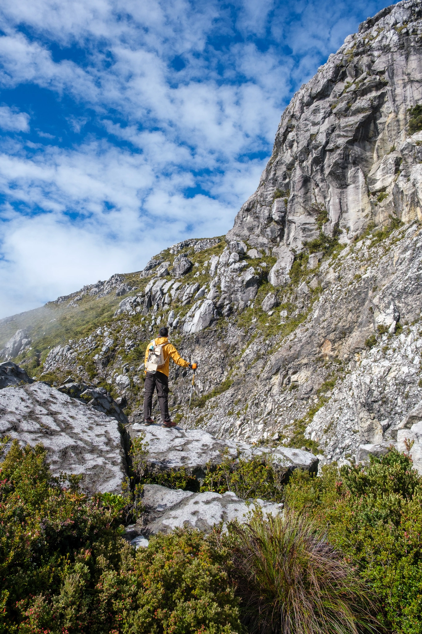 A hiker standing at a rock near the area of white sand at Mt. Apo