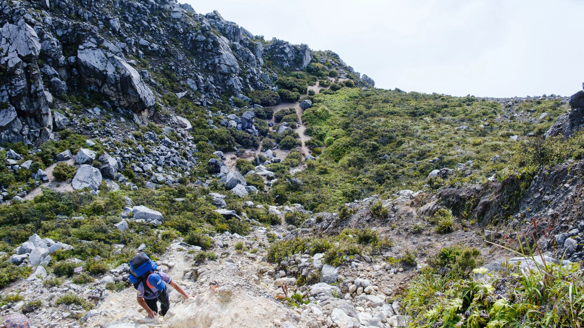 A guide climbing the rocks of Mt. Apo